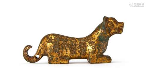 A CHINESE GILT BRONZE WEIGHT IN THE FORM OF A FELINE (TIGER)...