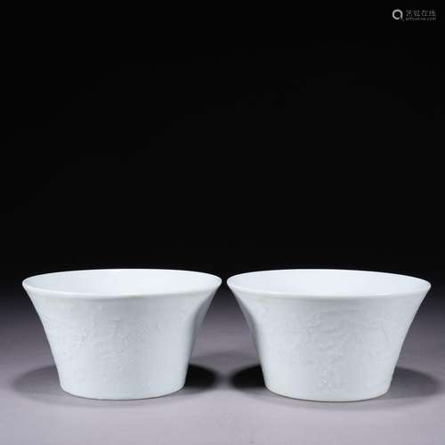 A pair of white glazed 'dragon and phoenix' bowl