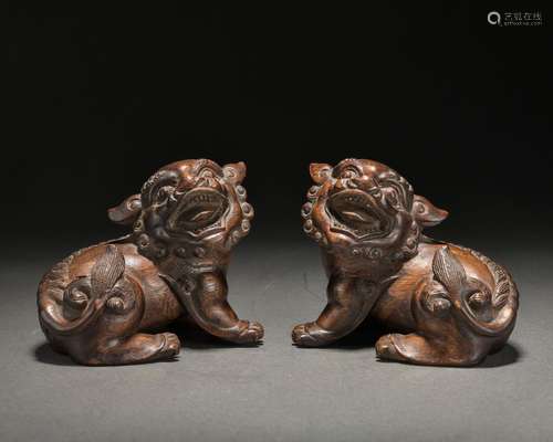 A pair of eaglewood 'lion' paperweight