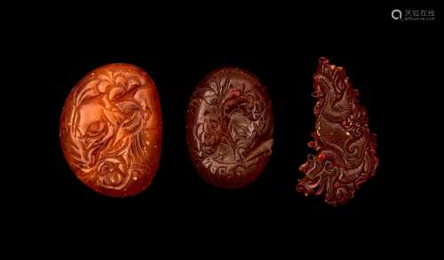 THREE CHINESE AMBER PENDANTS, QING DYNASTY (1644-1911)