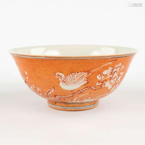 A Chinese bowl with an orange decor of birds and flowers. 19...