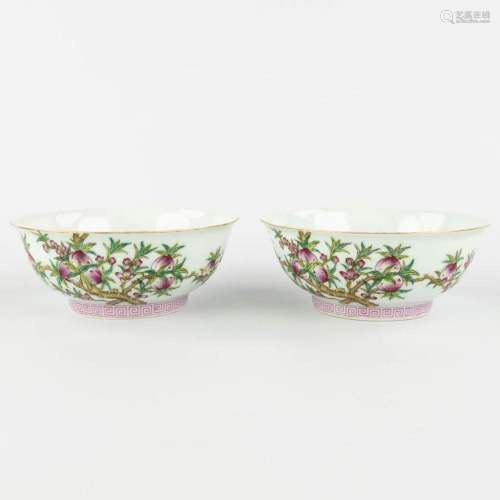 A pair of Chinese bowls, Famille rose decor of peaches. Yong...
