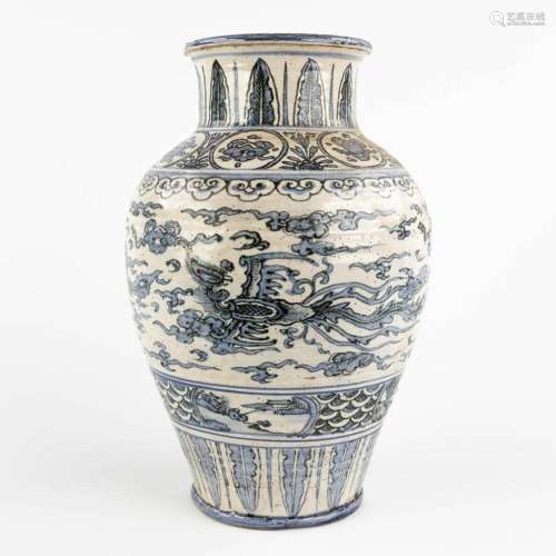 A Chinese vase, stoneware with blue-white glaze of a phoenix...