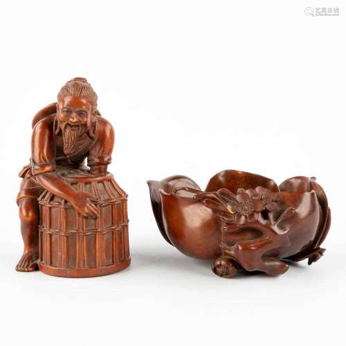 Two Chinese wood sculptures, a fisherman and a brushpot in t...