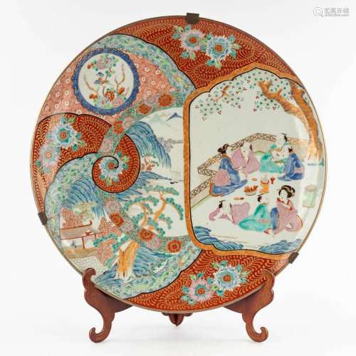 A large Japanese plate, Kutani, decorated with figurines. 19...