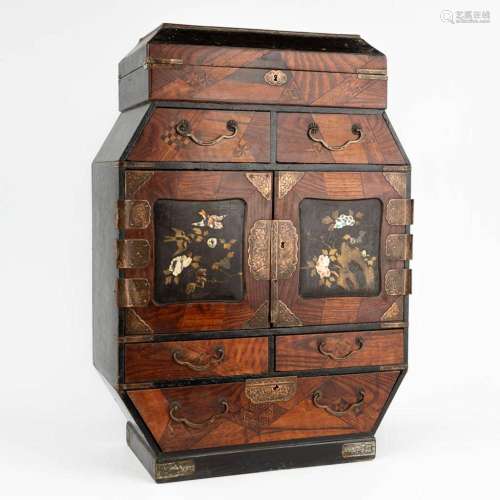 An antique Japanese jewelry box or cabinet inlaid with hardw...