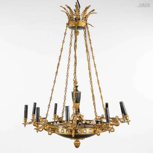 A chandelier, brass in Empire style with swan figurines, cir...