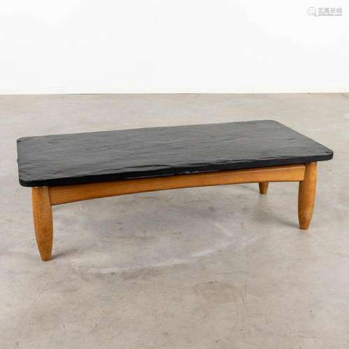 A large mid-century coffee table with a slate top, circa 196...