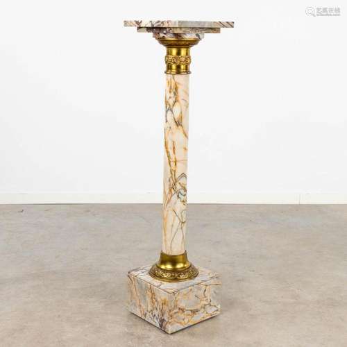 A marble pedestal mounted with bronze and a revolving top. (...