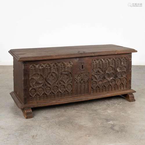 An antique chest with wood sculptured panels, Gothic Revival...