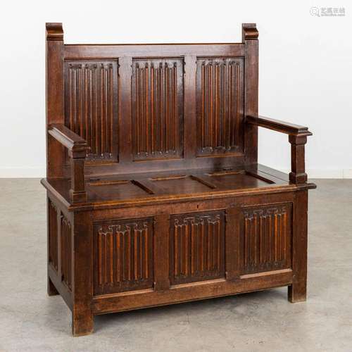 An antique hall bench, oak with sculptured panels in a Gothi...