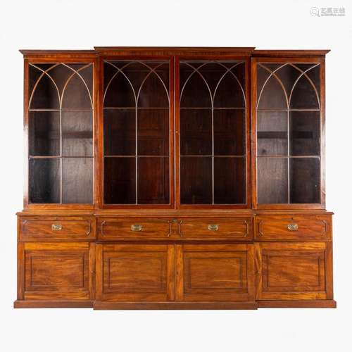 A monumental and antique English bookcase or library cabinet...