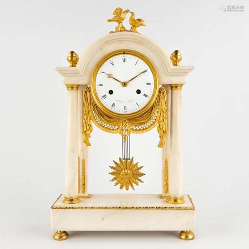 An antique column clock, gilt bronze and white marble. First...