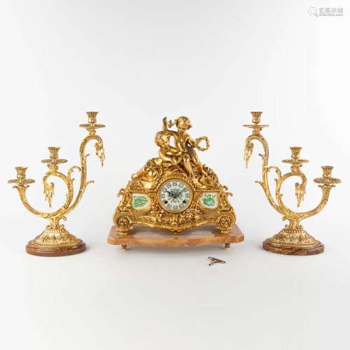 A three-piece mantle garniture clock and candelabra, bronze ...