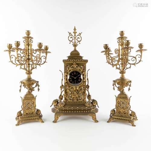 A three-piece mantle garniture clock and candelabra, bronze,...
