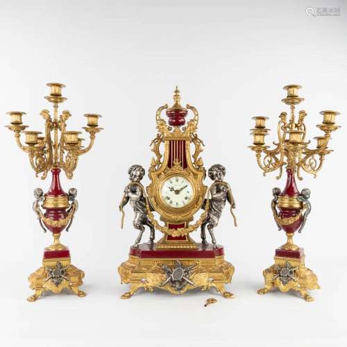 A three-piece mantle garniture clock and candelabra, Empire ...