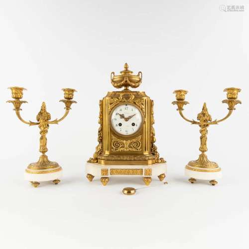 A three-piece mantle garniture clock, gilt bronze on white C...