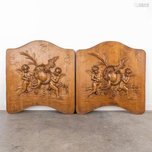 A pair of sculptured panels with images of putti. Circa 1900...