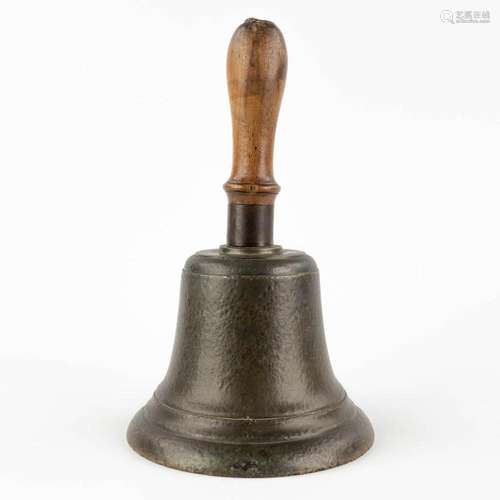 An antique 'Handbell' bronze with an inscription ...