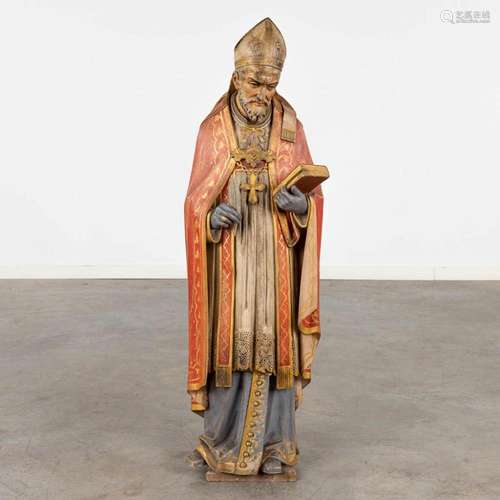 An antique wood sculptured figurine of a saint, original pol...