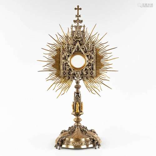 A sunburst monstrance, decorated with images of the stations...