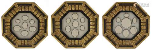 Three glazed octagonal frames containing a selection of plas...