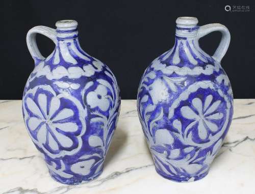 Pair of German stoneware flasks, with inscribed and blue sty...