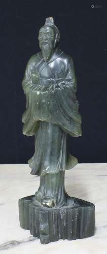 Chinese green hardstone figure of a man modelled standing in...