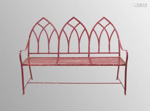 Gothic revival red painted wrought iron garden bench, with a...