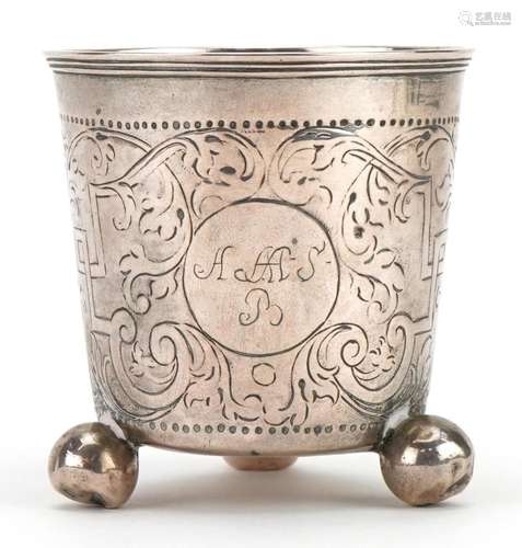 Antique silver cup with three ball feet and engraved decorat...