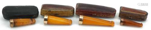 Four late19th/early 20th century butterscotch amber cigarett...