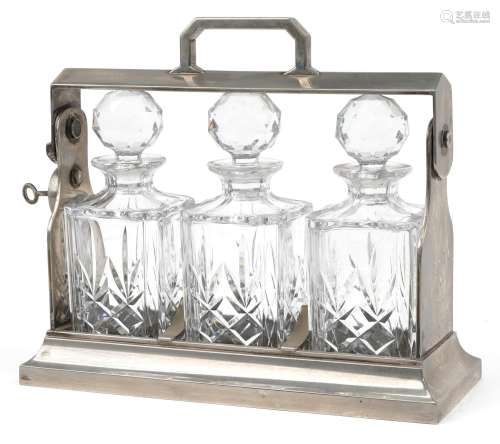 Silver plated three bottle tantalus stand with three cut gla...