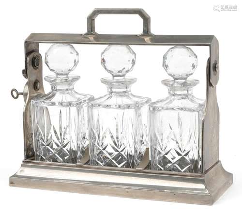 Silver plated three bottle tantalus stand with three cut gla...