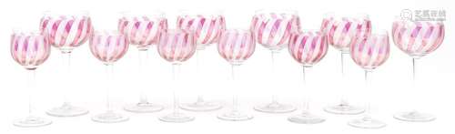 Two sets of six wine glasses with etched and cranberry decor...