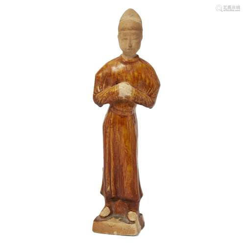 A Chinese amber glazed figure of an attendant<br />
<br />
T...