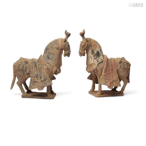 A pair of Chinese painted pottery figures of caparisoned hor...