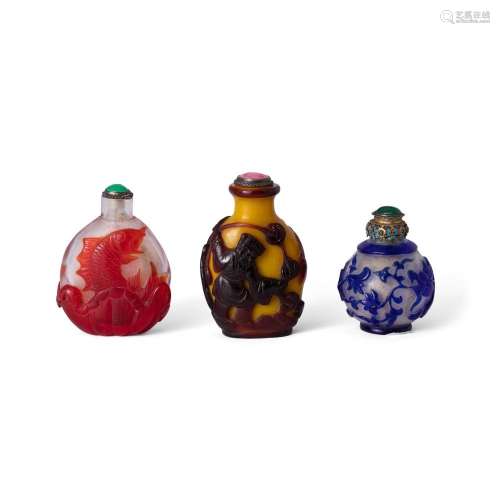 Three Chinese overlay glass snuff bottles<br />
<br />
Late ...