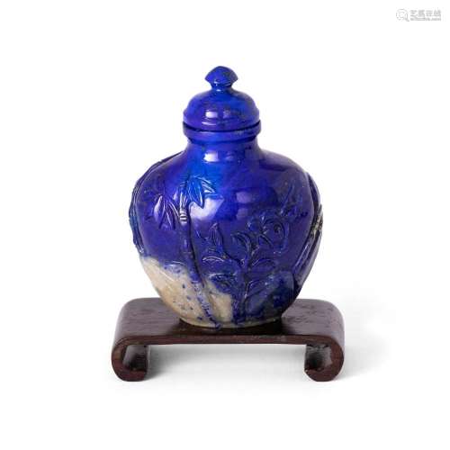 A Chinese carved lapis lazuli snuff bottle<br />
<br />
Late...
