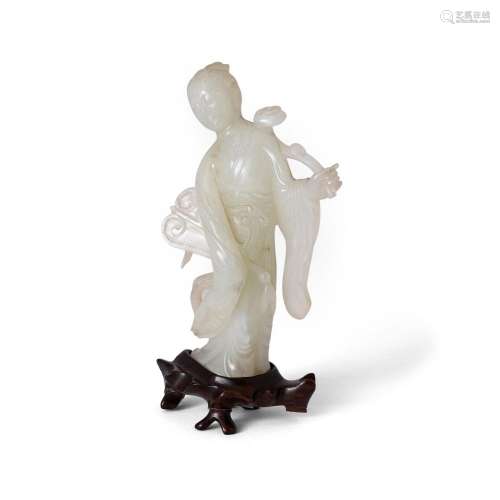 A Chinese pale jade carving of a standing beauty<br />
<br /...