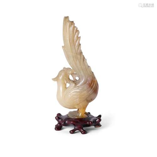 A Chinese green and russet hardstone carving of a phoenix<br...