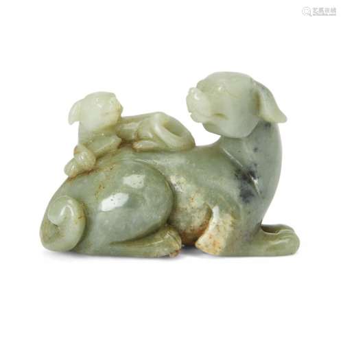 A Chinese russet and celadon jade carving of dogs<br />
<br ...