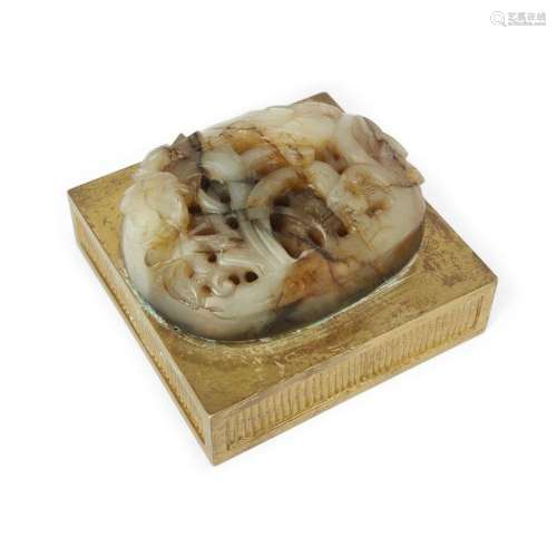 A Chinese reticulated pale and mushroom jade plaque mounted ...