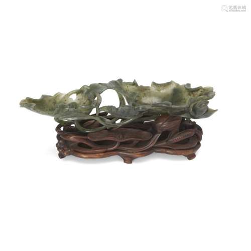 A Chinese spinach jade 'lotus leaf' washer, bixi<br />
<br /...