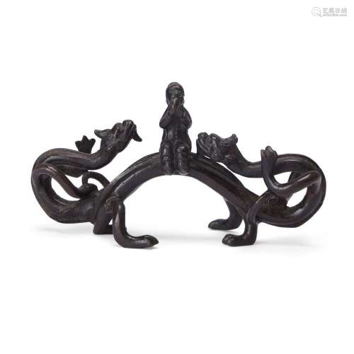 A Chinese bronze 'chilong and scholar' brush rest<br />
<br ...