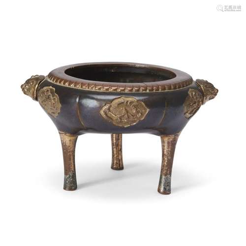 A Chinese parcel-gilt bronze tripod incense burner<br />
<br...