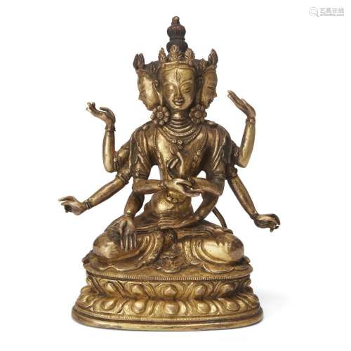 A Sino-Tibetan gilt-bronze figure of a multi-armed deity<br ...