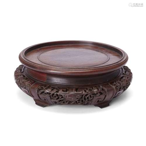 A large Chinese carved hardwood circular vase stand<br />
<b...