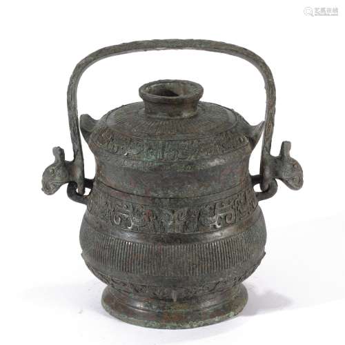 A BRONZE POT WITH LONG HANDLE