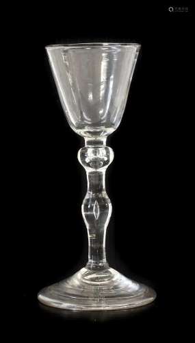 A Newcastle Light Baluster Wine Glass, circa 1740, the round...