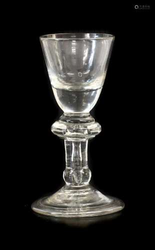 A Dram Glass, circa 1720, the rounded funnel bowl with solid...